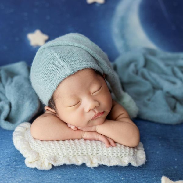Person stretching peacefully against a soft aqua background.